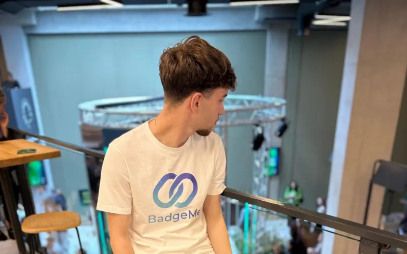 BadgeMe team member on the balcony above the Deep Tech Atelier 2026 crowd