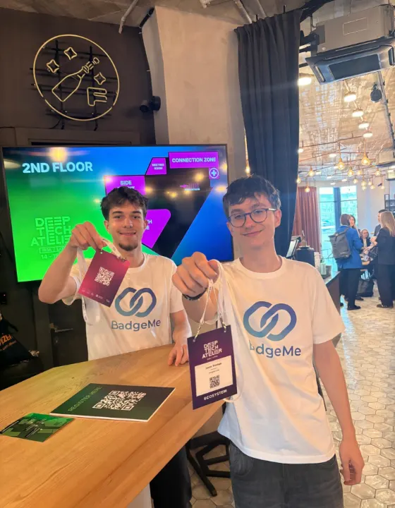 Attendees holding up their printed BadgeMe badges